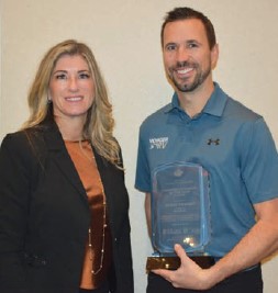 Melanie Taylor-Wallis presents the RV Dealer of the Year Award to Jason Friesen.